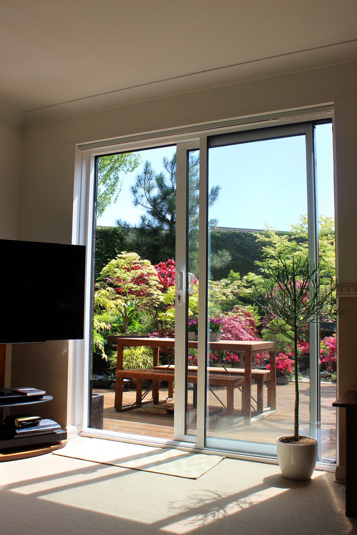 Image of aluminium patio doors overlooking back garden with decking